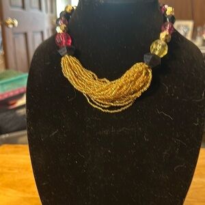 Beautiful vintage necklace. The seed beads are glass. rest of the beads plastic.